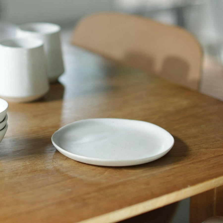 Elegant dessert plates set arranged on a dining table, showcasing refined style and sophistication