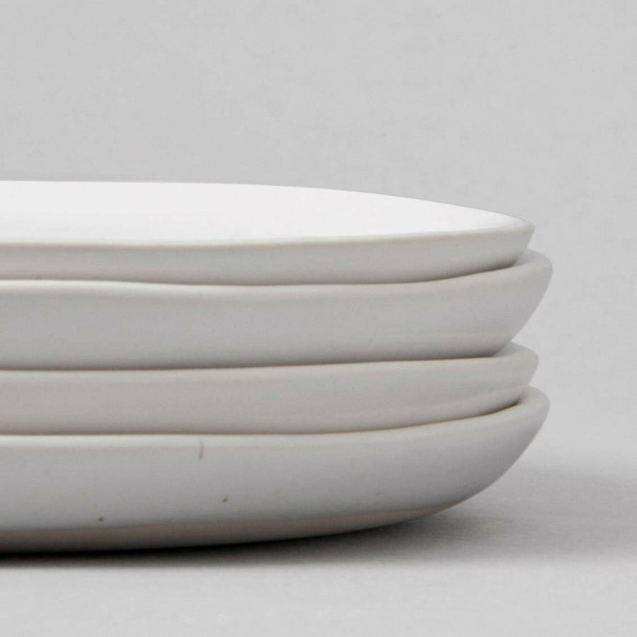 Elegant dessert plates set arranged on a dining table, showcasing refined style and sophistication