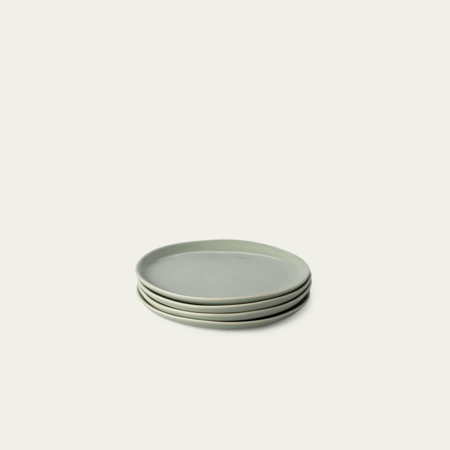 Elegant dessert plates set arranged on a dining table, showcasing refined style and sophistication