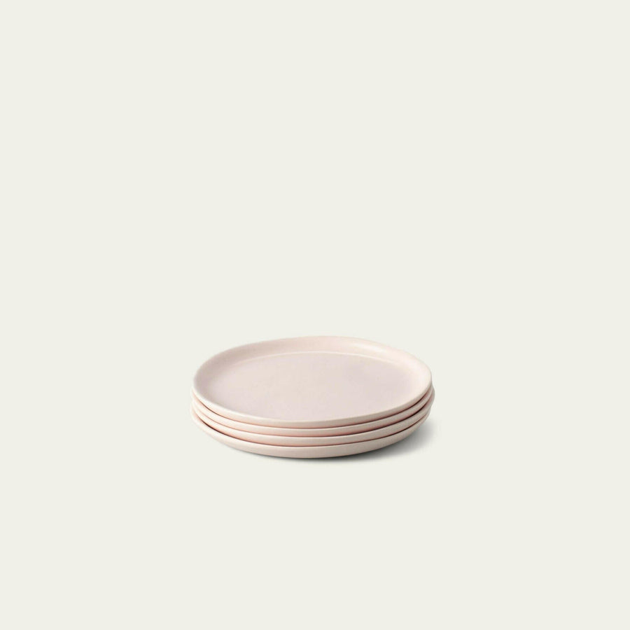 Elegant dessert plates set arranged on a dining table, showcasing refined style and sophistication