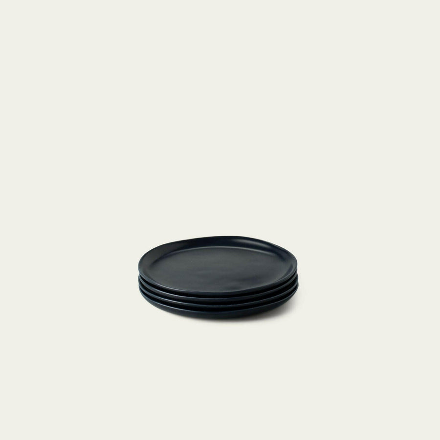 Elegant dessert plates set arranged on a dining table, showcasing refined style and sophistication