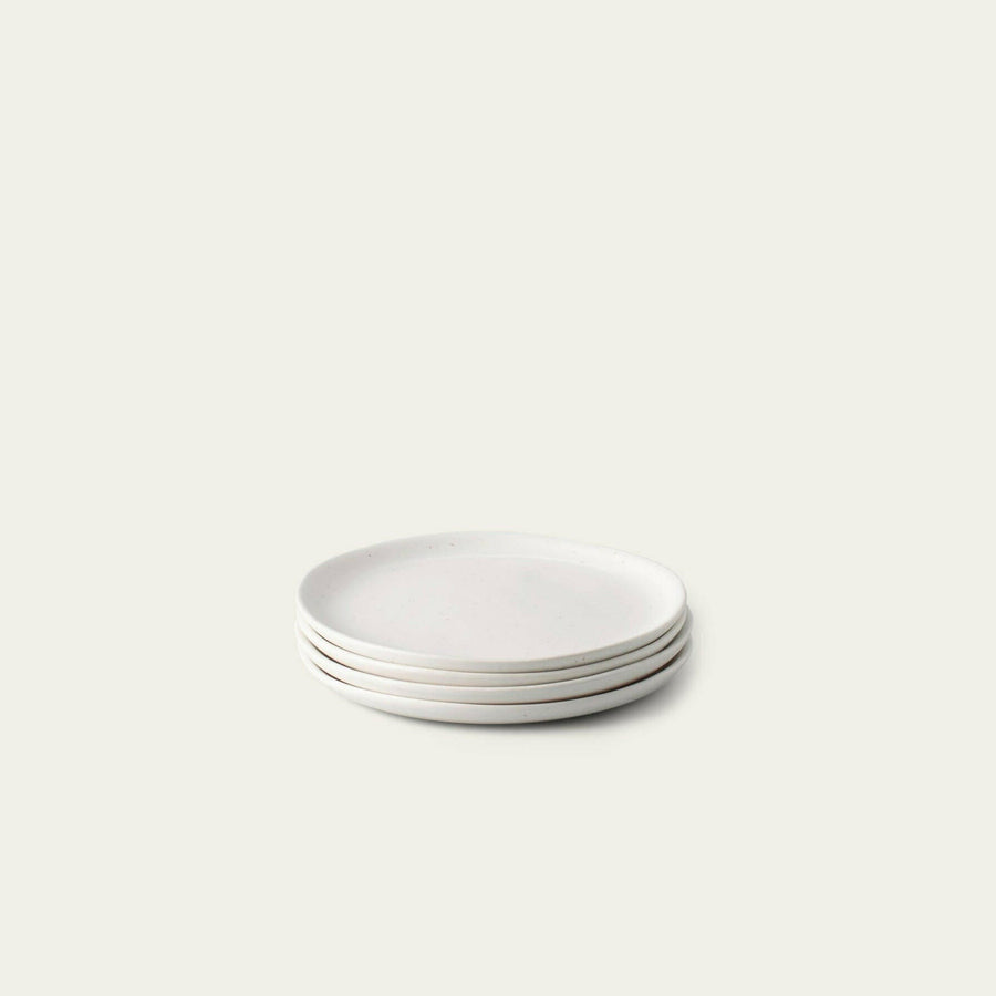Elegant dessert plates set arranged on a dining table, showcasing refined style and sophistication