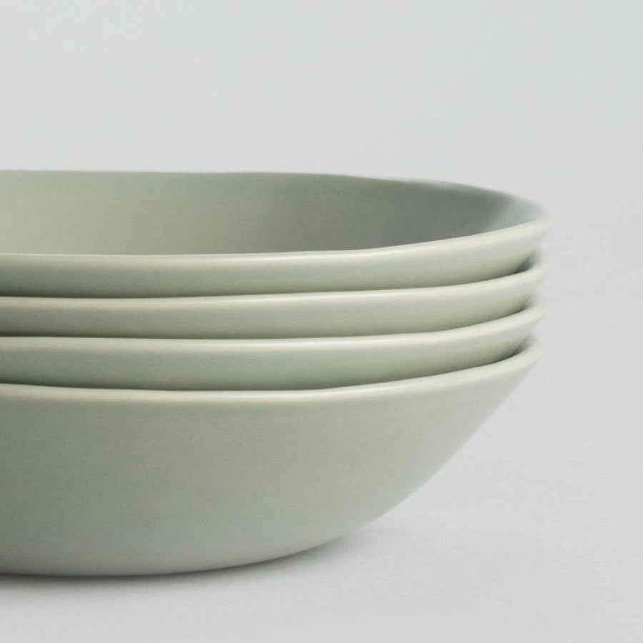 Elegant pasta bowls set on a dining table, showcasing refined craftsmanship and sophisticated design for upscale meals.