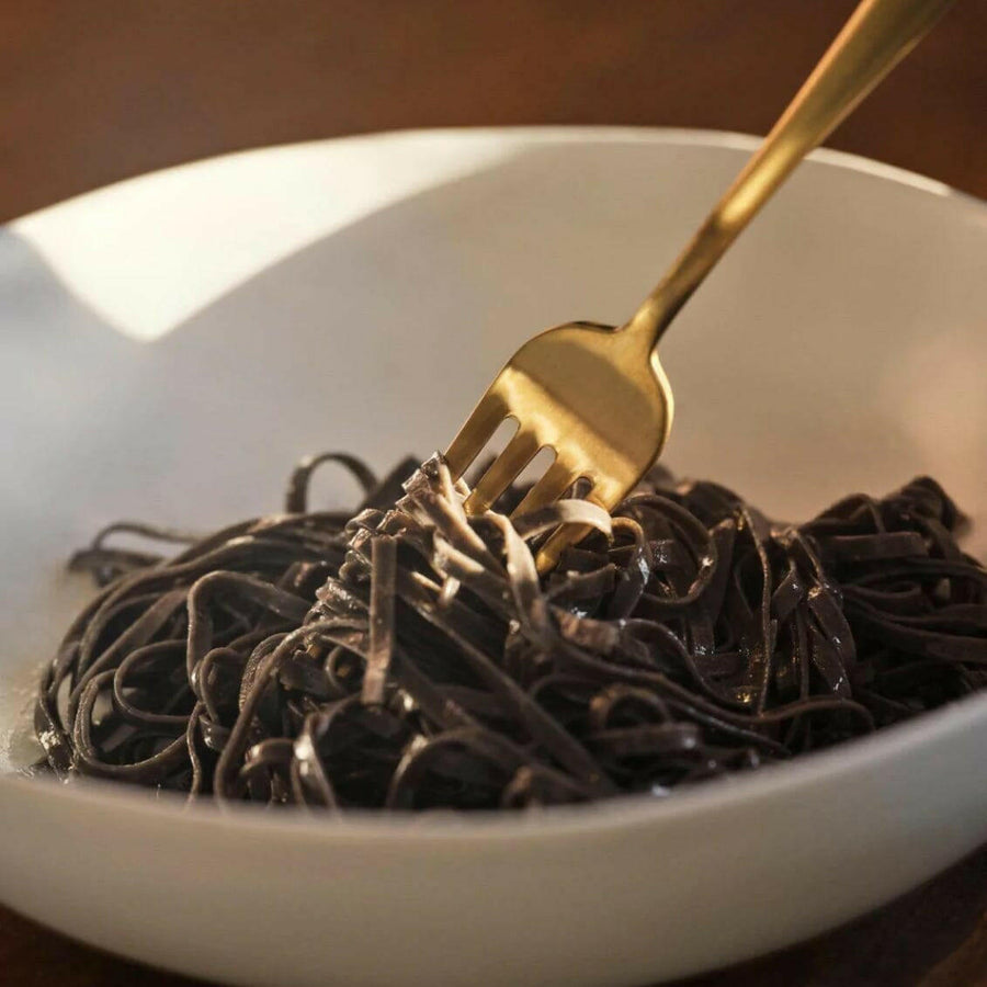 Elegant pasta bowls set on a dining table, showcasing refined craftsmanship and sophisticated design for upscale meals.
