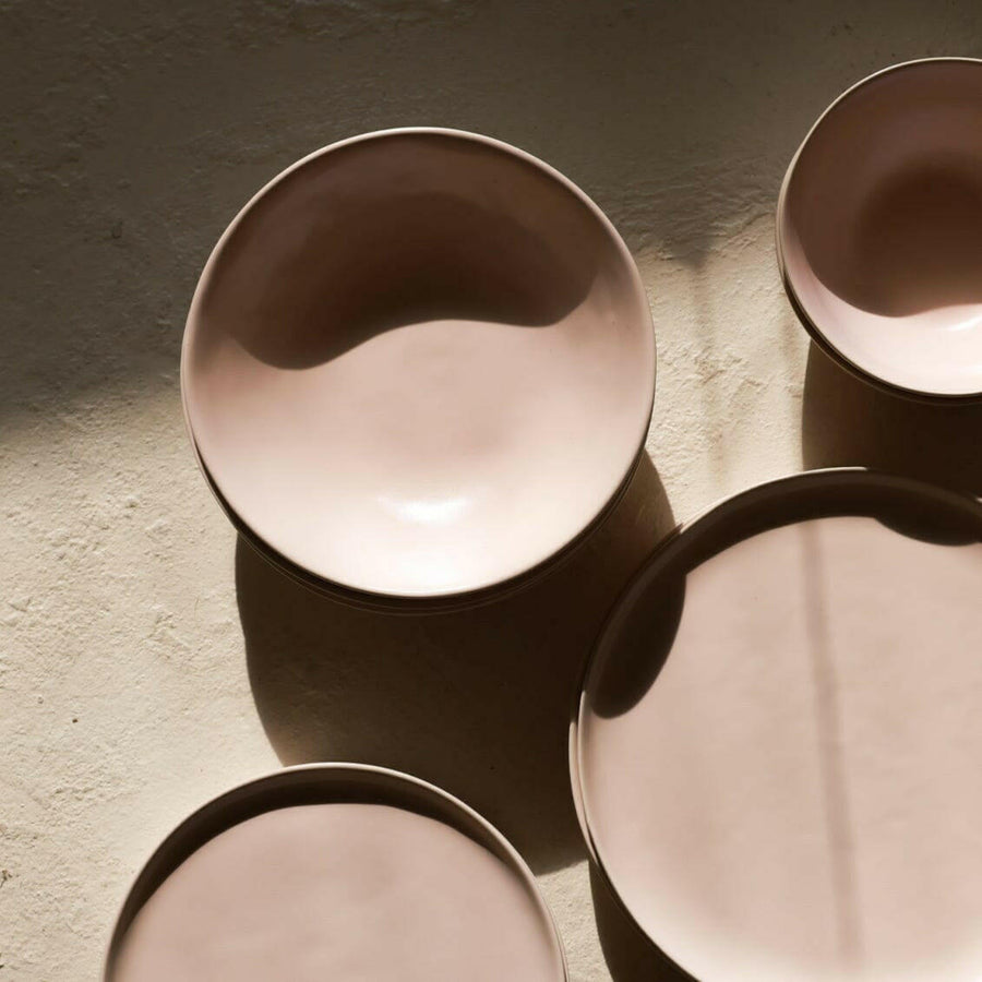 Elegant pasta bowls set on a dining table, showcasing refined craftsmanship and sophisticated design for upscale meals.