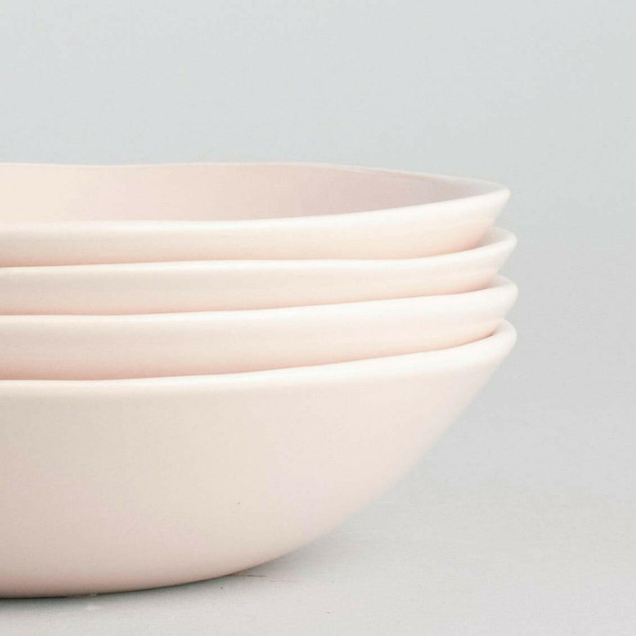 Elegant pasta bowls set on a dining table, showcasing refined craftsmanship and sophisticated design for upscale meals.