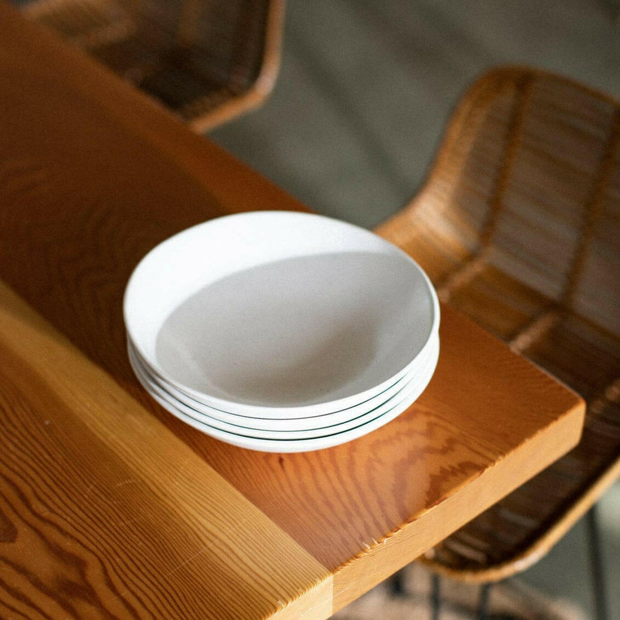Elegant pasta bowls set on a dining table, showcasing refined craftsmanship and sophisticated design for upscale meals.
