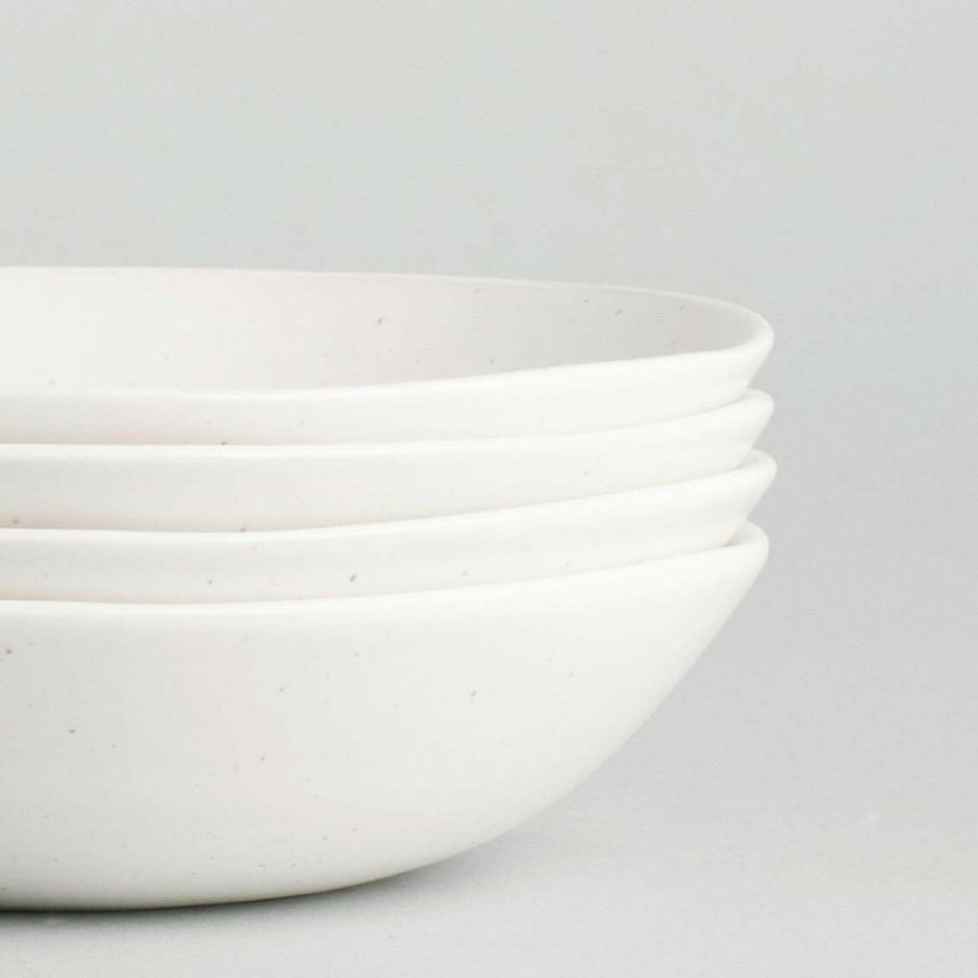 Elegant pasta bowls set on a dining table, showcasing refined craftsmanship and sophisticated design for upscale meals.
