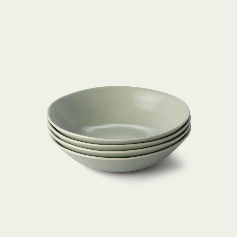 Elegant pasta bowls set on a dining table, showcasing refined craftsmanship and sophisticated design for upscale meals.