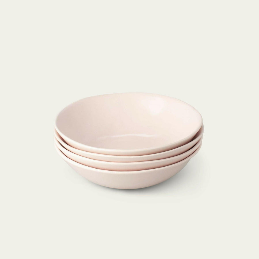 Elegant pasta bowls set on a dining table, showcasing refined craftsmanship and sophisticated design for upscale meals.