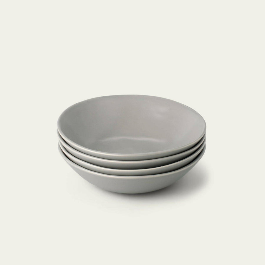 Elegant pasta bowls set on a dining table, showcasing refined craftsmanship and sophisticated design for upscale meals.