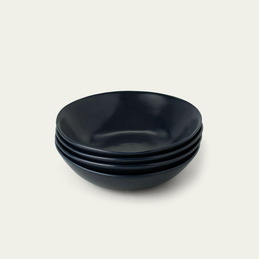 Elegant pasta bowls set on a dining table, showcasing refined craftsmanship and sophisticated design for upscale meals.